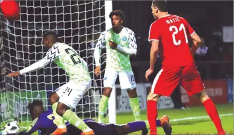  ??  ?? Super Eagles Goalkeeper, Francis Uzoho (sprawling on the turf) trying to stop Nemanja Matic’s (right) header from crossing his goal-line during the internatio­nal friendly between Nigeria and Serbia at the Hive Stadium in London…on Tuesday night