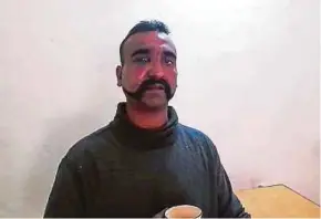  ?? AFP PIC ?? A photo released by Pakistan’s Inter Services Public Relations yesterday of a captured Indian pilot holding a cup of tea in the custody of Pakistani forces in an undisclose­d location.