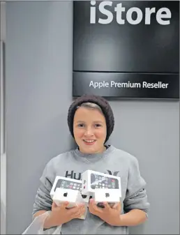  ?? PICTURE: WILLEM LAW ?? NEW TECHNOLOGY: Oliver Barrow, 12, queued outside the iStore at the V&A Waterfront from 4am yesterday to get his hands on the new iPhone 5S and 5C, launched in South Africa yesterday. He bought new phones for his entire family. The 5S has a R9 999...