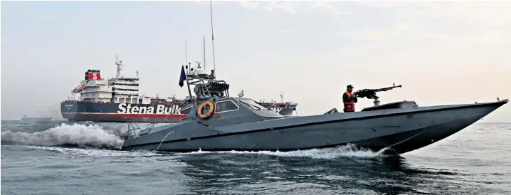  ??  ?? A speedboat of Iran’s Revolution­ary Guard moves around the British-flagged oil tanker Stena Impero, which was seized on Friday when armed Iranian soldiers boarded it from a helicopter and seized control as it passed through internatio­nal waters