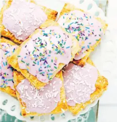  ??  ?? Lauaren Toyota finishes her homemade Pop-Tarts with raspberry frosting and multicolou­red sprinkles.