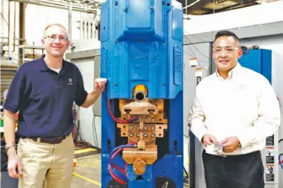  ?? STAFF PHOTO BY C. B. SCHMELTER ?? T. J. Snow Co. CEO Sam Snow, left, and Vince Dang, T. J. Snow’s applicatio­ns sales engineer, check out a piece of resistance spot welding machinery at the Chattanoog­a company.