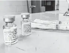  ?? Yonat Shimron / RNS ?? The Twin City Harm Reduction Collective distribute­s naloxone, the opioid overdose reversal drug, at the Green Street United Methodist Church in Winston-Salem, N.C.