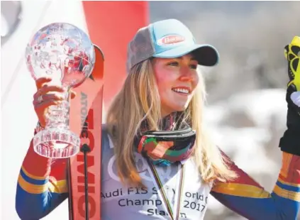  ??  ?? EagleVail phenom Mikaela Shiffrin, 22, displays her crystal globe trophy as she celebrates her World Cup overall title Saturday in Aspen, where she was runner-up in the slalom at the World Cup Finals. Helen H. Richardson, The Denver Post