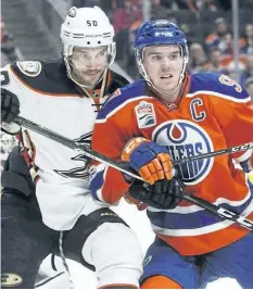  ?? THE CANADIAN PRESS FILES ?? Anaheim Ducks Antoine Vermette, left, battles with Edmonton Oilers centre Connor McDavid during an April 1 game in Edmonton. The Oilers beefed up their top line Tuesday as they prepared for the second-round series against the Ducks.