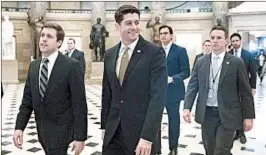  ?? SHAWN THEW/EPA ?? House Speaker Paul Ryan walks through Statuary Hall on his way to the House floor to vote on the stopgap funding bill. Now, the Senate must appprove its own bill.