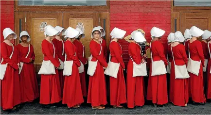  ?? PHOTO: REUTERS ?? Women dressed as handmaids promoting the TV series The Handmaid’s Tale, a story of a dystopic America.