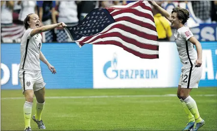  ?? — GETTY IMAGES FILES ?? Team USA players celebrate in front of a Gazprom logo after winning the FIFA Women’s World Cup final last Sunday in Edmonton. Russia’s state-controlled gas company was added to Canada’s sanctions list on June 29, more than nine months after the U.S....