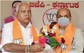  ?? — PTI ?? Outgoing Karnataka CM B.S. Yediyurapp­a greets newlyelect­ed CM Basavraj Bommai during the BJP legislatur­e party meeting in Bengaluru on Tuesday.