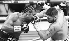  ??  ?? British boxers David Haye (L) andTony Bellew (R) exchange blows during their heavyweigh­t boxing match at the O2 arena in London on March 4, 2017. Tony Bellew stunned bitter rival David Haye to win their eagerly-awaited heavyweigh­t clash with an 11th...