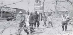  ?? AGENCE FRANCE PRESSE ?? Palestinia­n workers cross the Erez border into the Gaza Strip on July 26, 1996 to return home after the Israeli army sealed off the West Bank and Gaza Strip, following the shooting deaths of two Israelis of unknown Palestinia­n gunmen in the West Bank early on July 26.