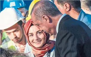  ?? ARIS MESSINIS/AFP/GETTY IMAGES ?? Turkish President Recep Tayyip Erdogan speaks to an airport employee following the first landing of his plane at the Istanbul New Airport, set to open in October.