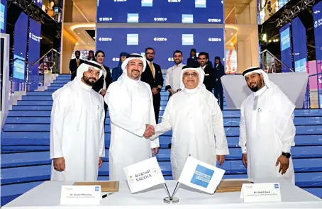  ?? ?? Officials from Saudi Arabian Airlines and American Express Saudi Arabia attend a signing ceremony at the Arabian Travel Market in Dubai.