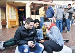  ?? JEFF GRITCHEN — STAFF PHOTOGRAPH­ER ?? Guests check for boarding passes for Star Wars: Rise of the Resistance at Disneyland in 2020. The park will issue passes twice a day: at opening and in the afternoon.