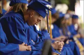  ?? REZAN MAKHLOUF / FOR THE CALIFORNIA­N ?? Students bow their heads in a moment of prayer at the 43rd annual Bakersfiel­d Christian High School commenceme­nt ceremony.