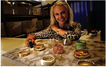  ??  ?? Cynthia Blais, founder and owner of Functional Wearables, poses for a portrait with some of her products at her company in San Diego, Calif. Blais designs and makes jewelery that disguises fitness tracker devices such as the Fitbit in a wide variety of...