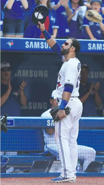  ?? VAUGHN RIDLEY/GETTY IMAGES ?? Toronto Blue Jays outfielder Jose Bautista tips his hat to the fans after he is pulled from the game in the ninth inning in Toronto on Sunday. The Jays beat the New York Yankees 9-5.