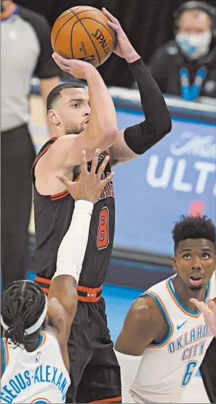  ?? SUE OGROCKI/AP ?? Bulls guard Zach LaVine shoots between Thunder defenders on Friday in Oklahoma City.