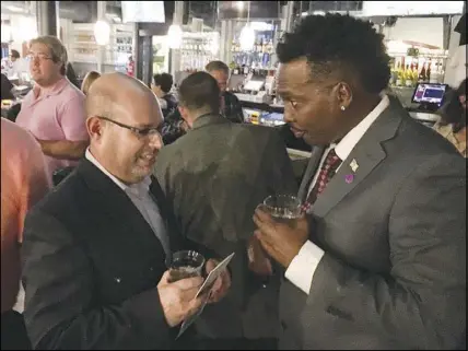  ?? YVONNE GONZALEZ ?? Libertaria­ns Gregg Luckner, left, and Robert Strawder talk during a Libertaria­n Party event Aug. 30 in downtown Las Vegas.