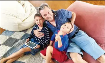  ?? ROBIN SPIESS ?? BongThom founder Ken White poses with his two children at his office, located in the Outpost co-working space in Phnom Penh.