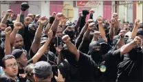  ?? PICTURE: AP ?? Masked members of the collective ‘500 Brothers’ take part in a march in support of the general strike in the capital of French Guiana, Cayenne.