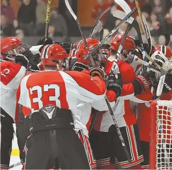  ?? HERALD PHOTOS BY JEFF PORTER ?? LAST LINE OF DEFENSE: Winchester freshman goalie Robert Divicenzo (1, left) makes one of his 24 saves on St. Mary’s junior forward Colin Reddy, then is mobbed by teammates (above) after their 3-2 victory yesterday in Woburn.