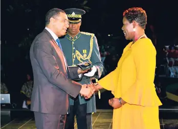  ??  ?? Janet Richards receives the Jamaica 55 Commemorat­ive Medal of Appreciati­on from Prime Minister Andrew Holness during the Jamaica 55 Appreciati­on Awards Ceremony held at Jamaica House last month.