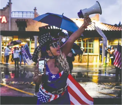  ?? CHANDAN KHANNA / AFP VIA GETTY IMAGES ?? Supporters pictured at a protest in Miami on Friday were not giving up hope for President Donald Trump's re-election, even as the sheer weight of the math facing the campaign began to grow heavy throughout the day.