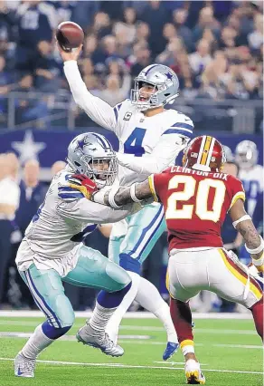  ?? MICHAEL AINSWORTH/ASSOCIATED PRESS ?? Dallas QB Dak Prescott (4) threw for 289 yards and two touchdowns and also ran for a score to help the Cowboys beat Washington Thursday.