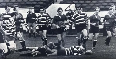  ??  ?? Tom Walsh scoring a try against N.I.F.C., with Mick Fitzpatric­k and Frank Ennis in support, and Irish great Mike Gibson third from right.