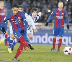  ??  ?? Barcelona’s Neymar scores a penalty against Real Sociedad at Anoeta stadium.