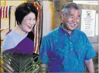  ?? Caleb Jones ?? Hawaii Gov. David Ige and first lady Dawn Amano Ige smile Wednesday after voting early in the state’s primary election in Honolulu. Igeisbeing challenged in his re-election bid by U.S.Rep. Colleen Hanabusa, who is giving up her seat in Congres.The Associated Press