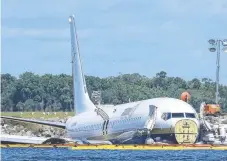  ?? Picture: AP ?? A charter plane carrying 143 people and travelling from Cuba to north Florida sits in a river at the end of a runway in Jacksonvil­le, Florida.