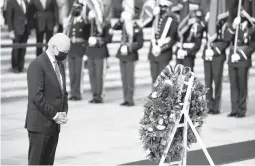 ?? EVAN VUCCI/AP ?? President Joe Biden bows his head during a wreath-laying ceremony to commemorat­e Veterans Day on Thursday at Arlington National Cemetery in Virginia.