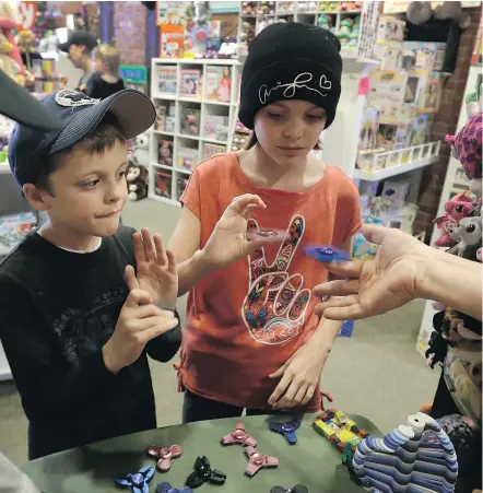  ?? — PHOTOS: THE ASSOCIATED PRESS ?? A selection of fidget spinners at the Funky Monkey Toys store in Oxford, Mich., where the toy has been flying off of the shelves. Owner Tom Jones says he sells up to 150 per day.