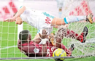  ?? — AFP photo ?? Marseille's French midfielder Florian Thauvin (top) scores a goal during the French L1 football match Olympique de Marseille versus Metz on February 2, 2018 at the Velodrome stadium in Marseille, southern France.