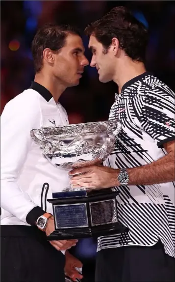  ??  ?? Rafael Nadal congratula­tes Roger Federer after his win in the Australian Open final.
