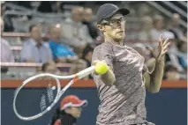  ??  ?? Peter Polansky returns against Vasek Pospisil Monday night en route to a 7-5, 6-2 win. Polansky faces No. 2 seed Roger Federer Wednesday afternoon.