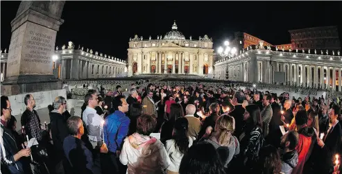  ?? CLAUDIO PERI / ANSA VIA THE ASSOCIATED PRESS ?? People hold candles at a vigil for Alfie Evans in St. Peter’s Square at the Vatican on Thursday.