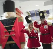  ?? MARY ALTAFFER — ASSOCIATED PRESS ?? FAO Schwarz employees dressed as toy soldiers pose for a photo during a media preview of the new store at Rockefelle­r Center in Manhattan on Tuesday.