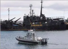  ?? The Canadian Press ?? A Canadian Fisheries and Oceans patrol boat passes by the Sea Shepherd Conservati­on Society vessel Farley Mowat in Sydney, N.S.