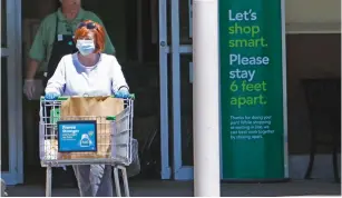  ??  ?? A SHOPPER exits a supermarke­t during the coronaviru­s pandemic. (TNS)