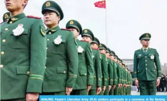  ?? _—AFP ?? NANJING: People’s Liberation Army (PLA) soldiers participat­e in a ceremony at the Nanjing Massacre Memorial Hall in Nanjing.