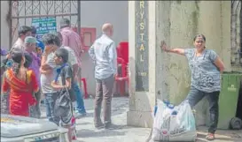  ?? PRATIK CHORGE/HT ?? Residents outside Crystal Tower; (right) BMC workers clear the debris.