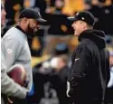  ?? KENNETH K. LAM/BALTIMORE SUN ?? Ravens coach John Harbaugh, right, talks with Steelers coach Mike Tomlin before last season’s game.