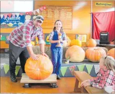  ??  ?? ASHLEE Filer with her dad Neil, Big Burt the pumpkin and the Cup.