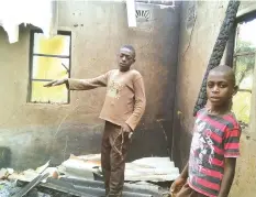  ??  ?? Flashback 2015... Machikiti's two sons show what remains after thier first house was torched by unknown assailants.