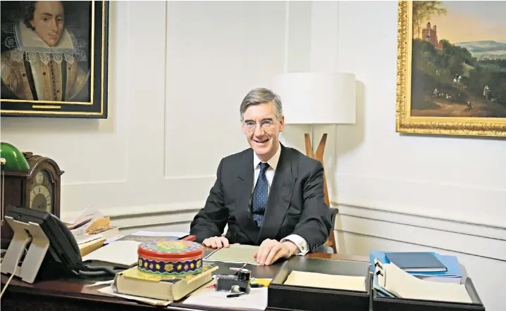  ?? ?? Jacob Rees-mogg sits pointedly behind his desk – where his Cadbury Creme Eggs tin sits – as he devises ways to measure office attendance