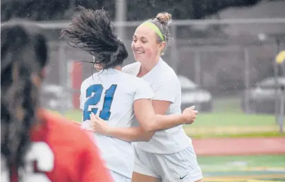  ?? SHAWN MCFARLAND / HARTFORD COURANT PHOTOS ?? Southingto­n sophomore Julia Rusiecki, left, hugs a teammate after scoring a goal in the Blue Knights’ 4-2 soccer win over Conard on Thursday. Rusiecki scored twice in the game.