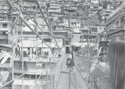  ?? SSB photo ?? PICTURE PERFECT. Since its opening a few years back, the StoBoSa Hillside Homes Artwork has become an instant tourist attraction in La Trinidad, Benguet.